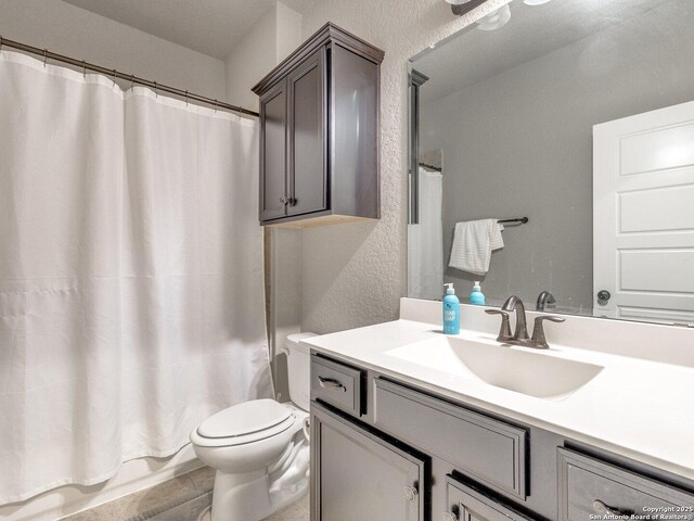 full bathroom with vanity, toilet, and shower / bath combo with shower curtain