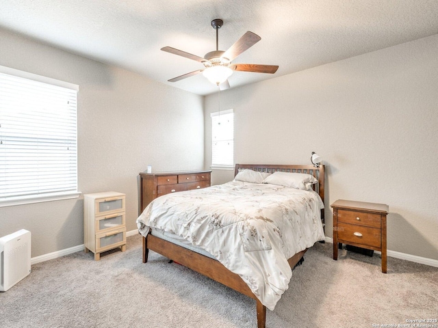 bedroom featuring ceiling fan and light carpet