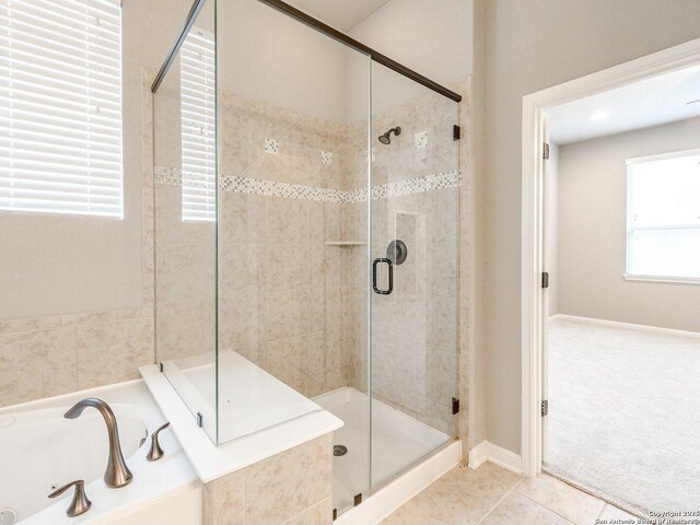 bathroom with tile patterned flooring and independent shower and bath