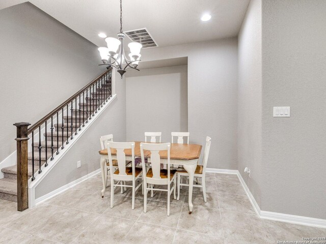 tiled dining area with a notable chandelier