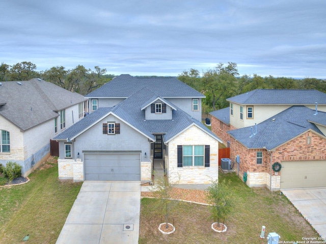 view of front property featuring central AC unit, a garage, and a front lawn