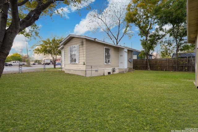 rear view of property with a lawn