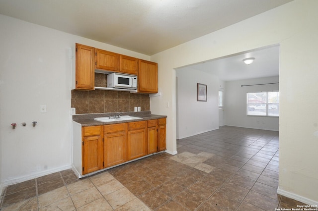 kitchen with decorative backsplash and sink