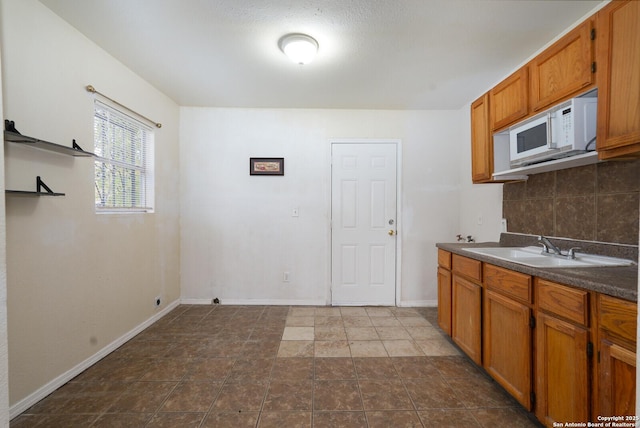 kitchen featuring decorative backsplash and sink