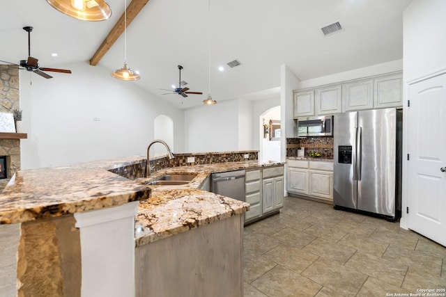 kitchen with ceiling fan, sink, beamed ceiling, backsplash, and appliances with stainless steel finishes