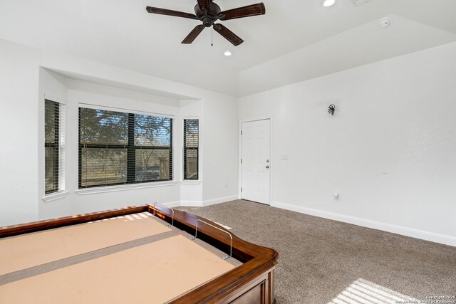 unfurnished bedroom featuring carpet floors, ceiling fan, and lofted ceiling