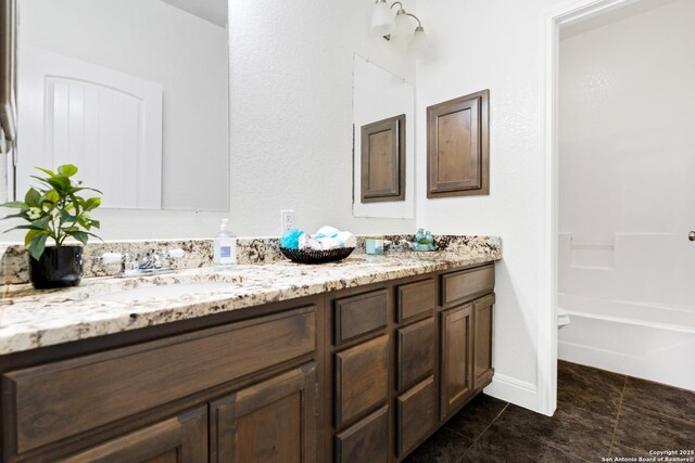 bathroom with washtub / shower combination and vanity