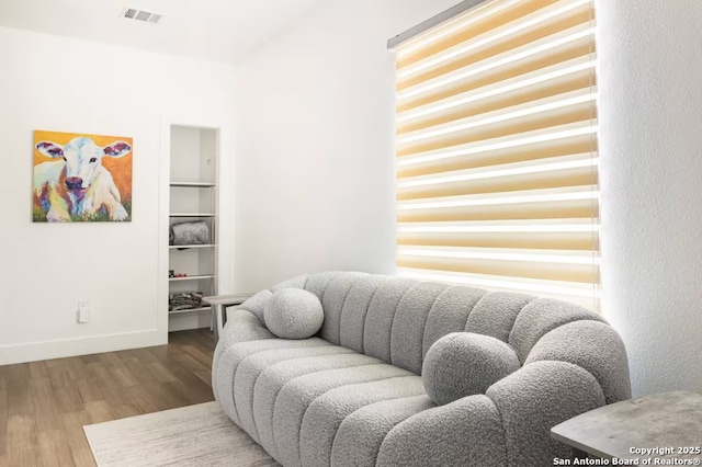 living room featuring hardwood / wood-style floors and built in features