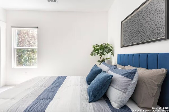 bedroom featuring multiple windows