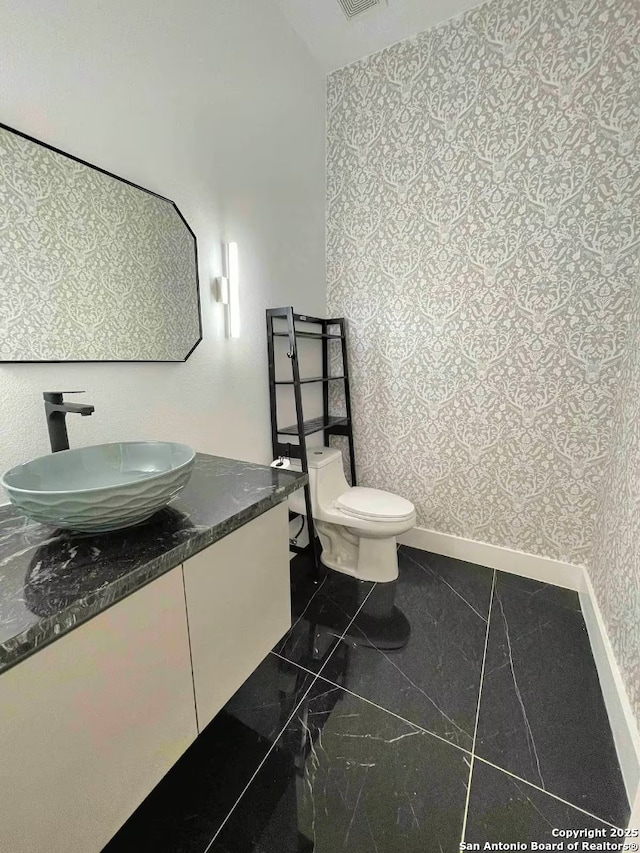 bathroom featuring vanity and toilet