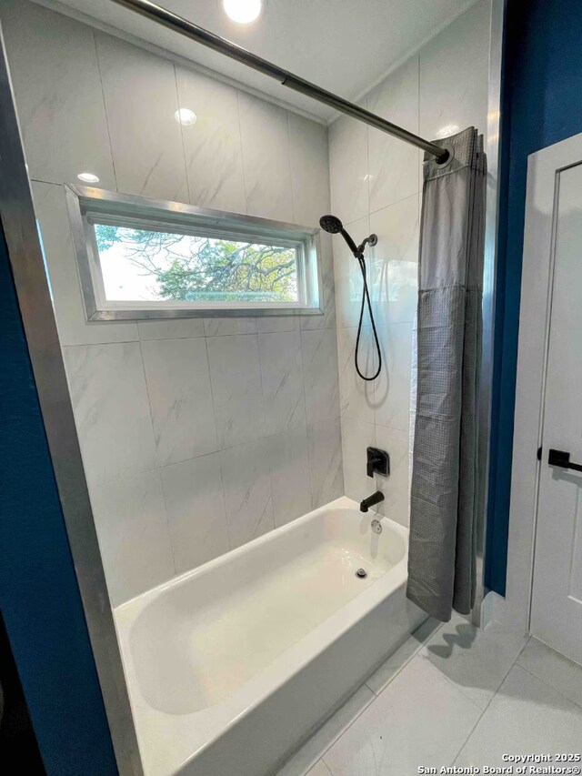 bathroom with tile patterned floors, a healthy amount of sunlight, and shower / bath combo