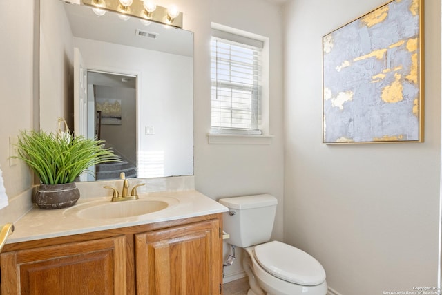 bathroom with vanity and toilet