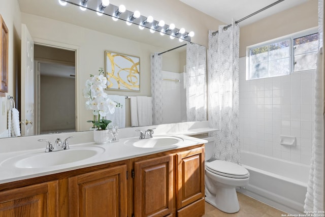 full bathroom featuring tile patterned floors, vanity, toilet, and shower / tub combo with curtain