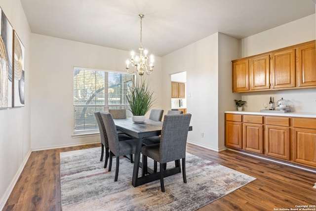 dining room with dark hardwood / wood-style flooring and a chandelier