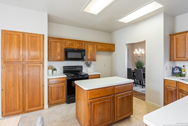 kitchen with black appliances, a kitchen island, and an inviting chandelier