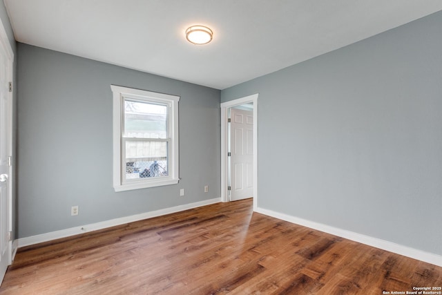 empty room with hardwood / wood-style floors