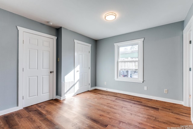 unfurnished bedroom with wood-type flooring