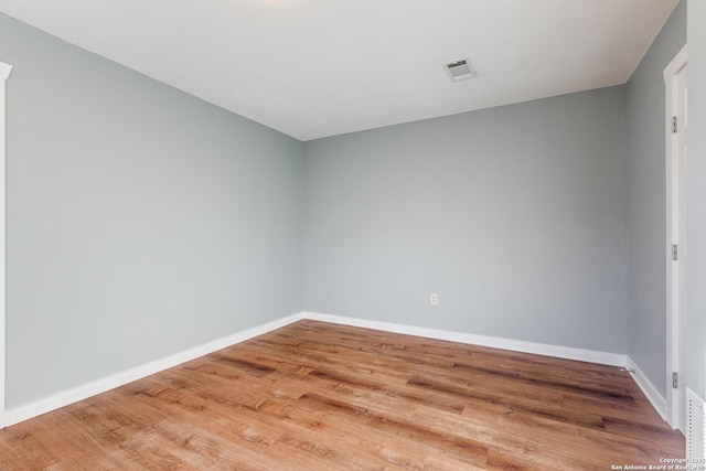 empty room with hardwood / wood-style flooring