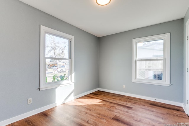 empty room with light hardwood / wood-style flooring