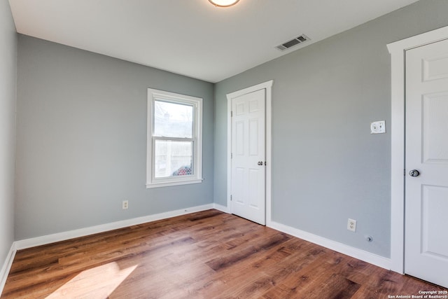 spare room featuring hardwood / wood-style flooring