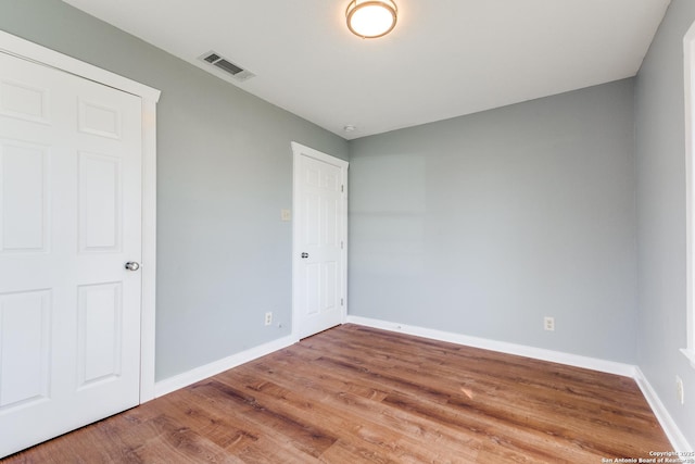 unfurnished room with hardwood / wood-style floors