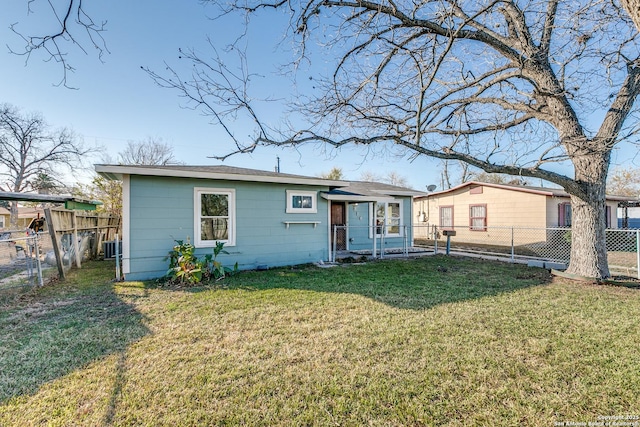 back of house with a lawn