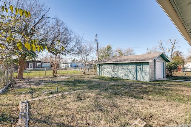 view of yard featuring a garage and an outdoor structure