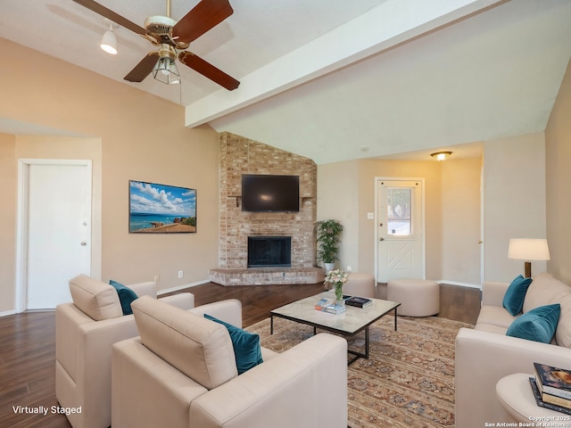 living room featuring hardwood / wood-style floors, vaulted ceiling with beams, ceiling fan, and a fireplace