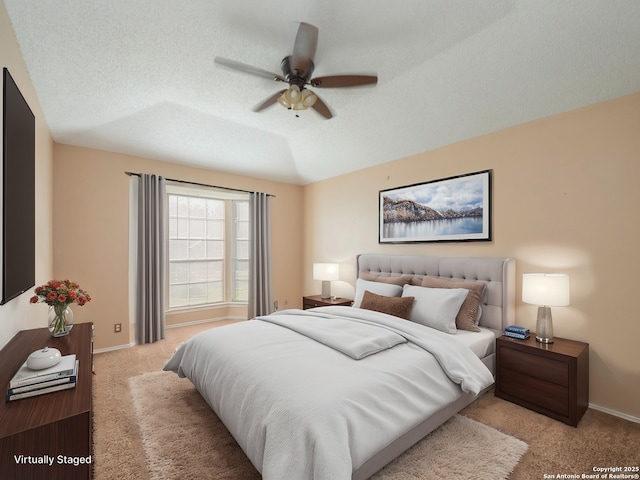 bedroom featuring vaulted ceiling, ceiling fan, light colored carpet, and a textured ceiling