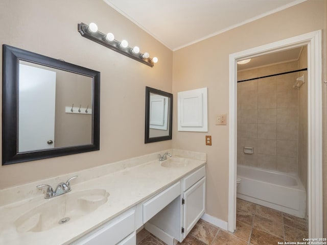 bathroom featuring vanity, tiled shower / bath, and ornamental molding