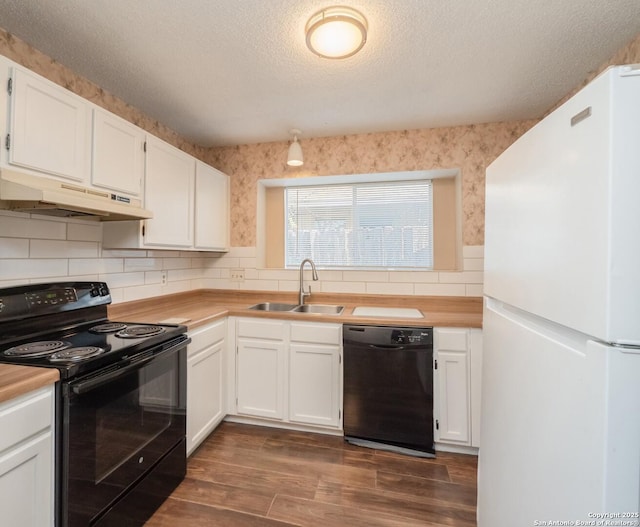 kitchen featuring a textured ceiling, sink, black appliances, dark hardwood / wood-style floors, and white cabinetry