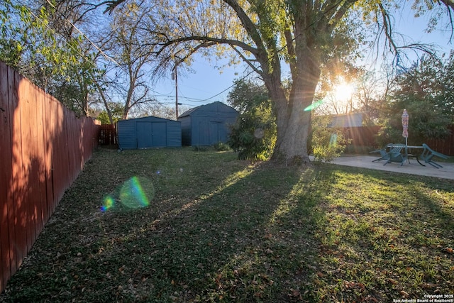 view of yard featuring a patio area and a shed