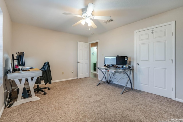 carpeted home office featuring ceiling fan