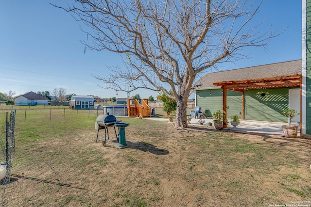 view of yard featuring a pergola and a playground