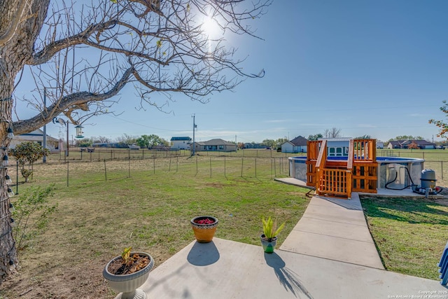 view of yard with a rural view and a patio