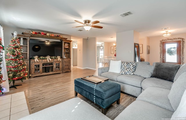 living room featuring wood-type flooring and ceiling fan