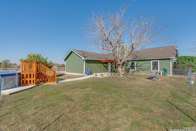 rear view of property with a lawn