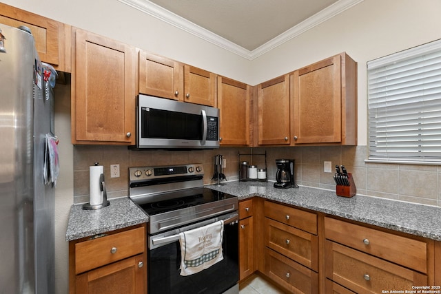 kitchen featuring backsplash, crown molding, stainless steel appliances, and stone countertops