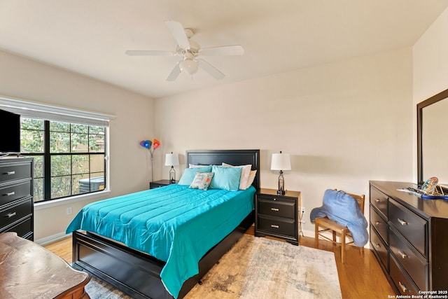 bedroom with ceiling fan and light hardwood / wood-style flooring