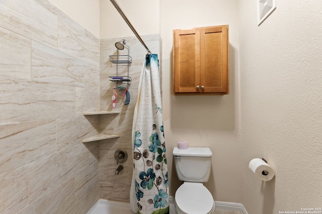 bathroom with toilet and a shower with shower curtain