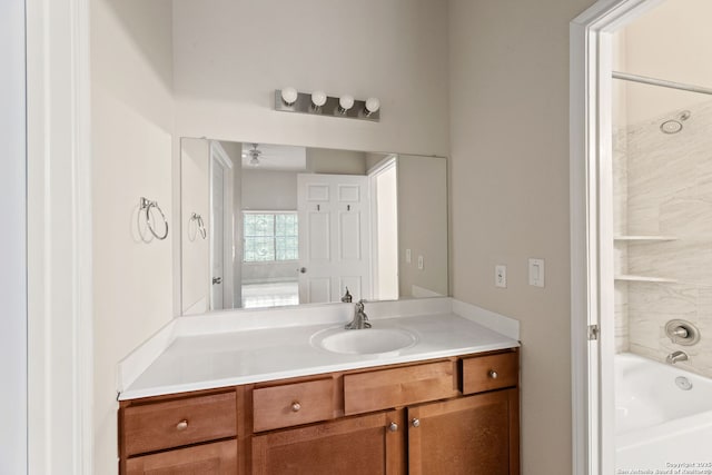 bathroom featuring vanity, shower / bathtub combination, and ceiling fan