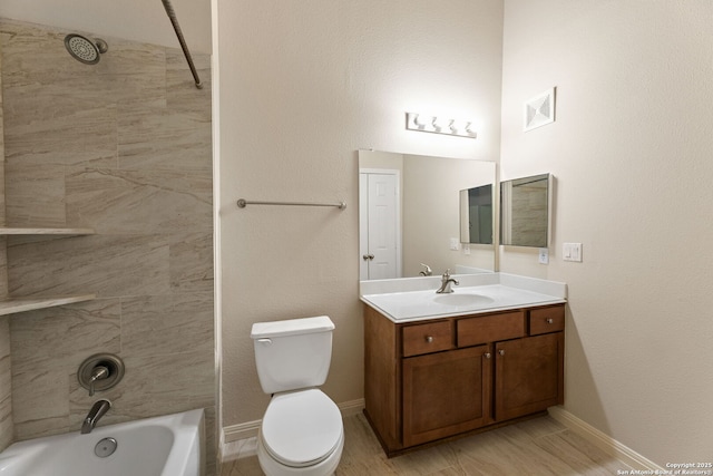 full bathroom featuring vanity, tiled shower / bath combo, and toilet