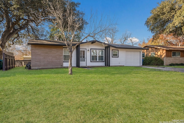 ranch-style home with a front yard and a garage