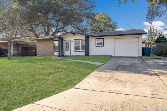 single story home with a garage and a front lawn