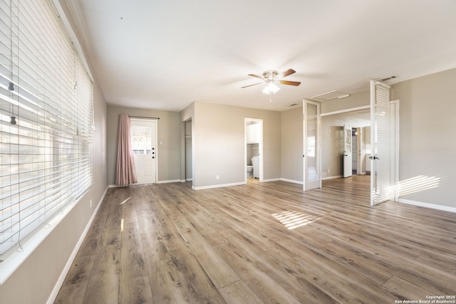 unfurnished living room with hardwood / wood-style flooring and ceiling fan