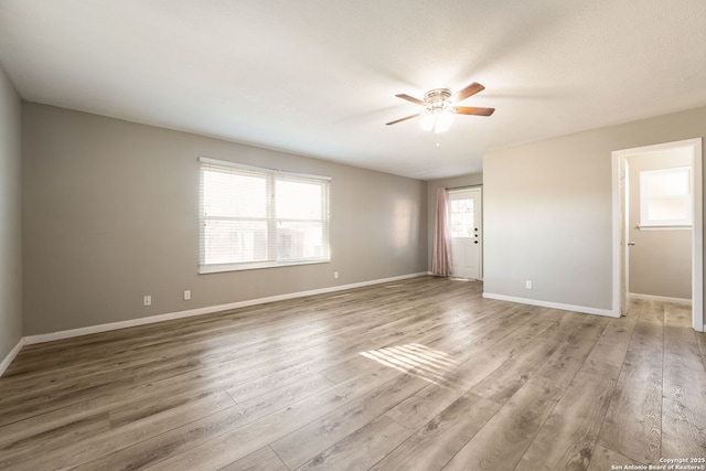 empty room featuring ceiling fan and light wood-type flooring