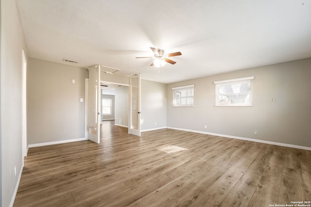 unfurnished room featuring hardwood / wood-style flooring, plenty of natural light, and ceiling fan