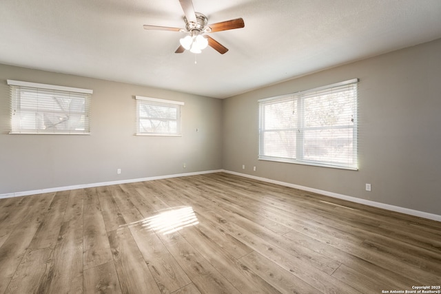 spare room with light wood-type flooring and ceiling fan