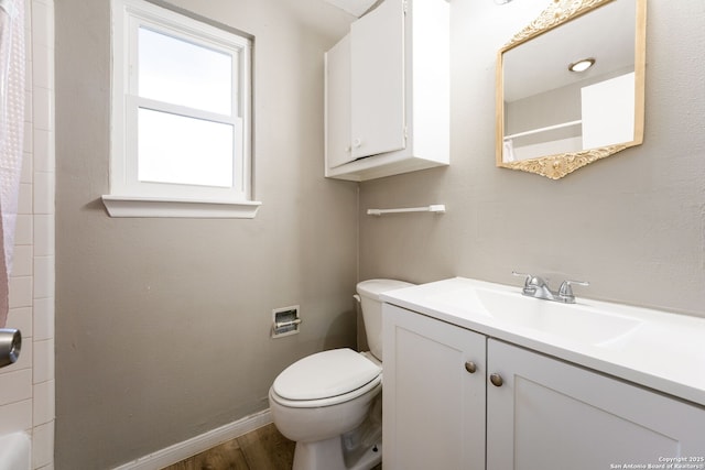 bathroom with vanity, toilet, wood-type flooring, and walk in shower