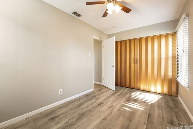 spare room featuring light wood-type flooring and ceiling fan